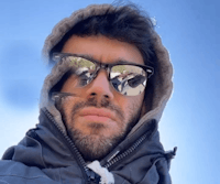 a man wearing sunglasses and a hoodie